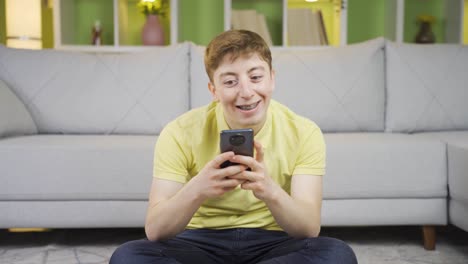 Young-man-texting-on-the-phone-in-happy-mood.
